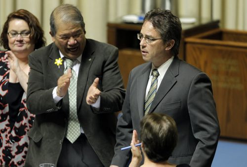 Manitoba's new finance minister presented his first budget in Winnipeg on Thursday afternoon. In this photo new Interlake MLA Thomas Nevakshonoff, right, reacts to his first ever question in the house. BORIS MINKEVICH/WINNIPEG FREE PRESS APRIL 30, 2015