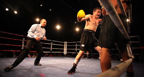 High Stakes Havoc - Winnipeger Kelly Page, on his way to a professional debut win, delivers a blow to Dia Grant's midsection Thursday night at Club Regent. April 30, 2015 - (Phil Hossack / Winnipeg Free Press)