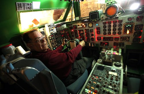 Chris Bell, an electronics and aircraft junkie sits in a simulated cockpit of a 1970s commercial jetliner in one of the hangars at Bob Diemert's  "Friendship Field" airstrip at Carman Mb. See Bill Redekop story.  May 1, 2015 - (Phil Hossack / Winnipeg Free Press)