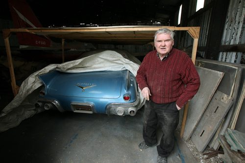 Bob Diemert lifts a tarpto show off his one of a kind 1957 Cadillac Eldorado stored for the winter in one of the hangar/workshops at his "Friendship Field" airstrip at Carman Mb. See Bill Redekop story.  May 1, 2015 - (Phil Hossack / Winnipeg Free Press)