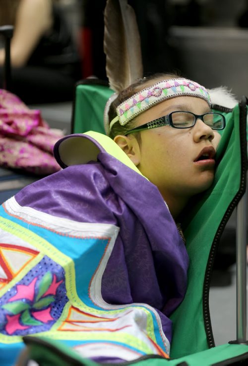 Shyla Boubard, 12, from Sagkeeng First Nation, resting after performing in the Grand Entrace at the 26th Annual Traditional Graduation Pow Wow for Indigenous Students at the University of Manitoba, Saturday, May 2, 2015. (TREVOR HAGAN/WINNIPEG FREE PRESS)