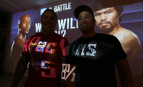 Manny Pacquiao fans, Charles Cruz and his brother Chris, who are watching the fight on a 300" screen from a projector temporarily setup just for tonight as he gets set to fight Floyd Mayweather Saturday, May 2, 2015. (TREVOR HAGAN/WINNIPEG FREE PRESS)