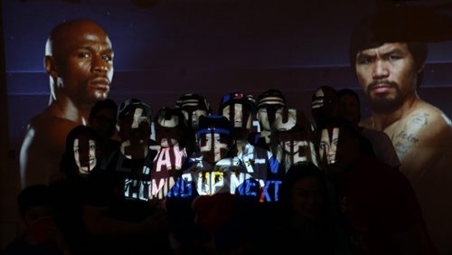 Using a projector he temporarily setup, Charles Cruz and his friends and family, ready to watch Manny Pacquiao fight Floyd Mayweather in Las Vegas tonight, Saturday, May 2, 2015. (TREVOR HAGAN/WINNIPEG FREE PRESS)