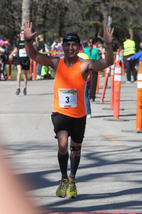 Winnipeg Police Service Officer Jimmy Anis crosses the finished first among the department in the Winnipeg Police Half-Marathon at Assiniboine Park Sunday morning. 150503 - Sunday, May 03, 2015 -  (MIKE DEAL / WINNIPEG FREE PRESS)