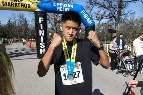 Allex Delacruz is jubilant after finishing the Winnipeg Police Half-Marathon at Assiniboine Park Sunday morning. 150503 - Sunday, May 03, 2015 -  (MIKE DEAL / WINNIPEG FREE PRESS)
