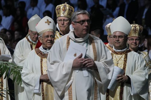 Thousands of Catholics gathered at the MTS Centre to take part in the Centennial Mass Sunday afternoon. The procession of priests walk onto the floor of the arena at the beginning of the event. 150503 - Sunday, May 03, 2015 -  (MIKE DEAL / WINNIPEG FREE PRESS)