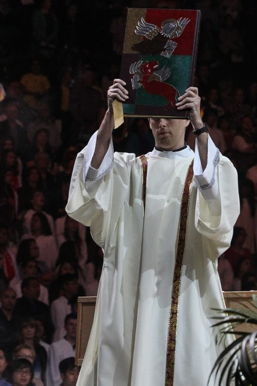 Thousands of Catholics gathered at the MTS Centre to take part in the Centennial Mass Sunday afternoon. A priest carries a holy book across the floor. 150503 - Sunday, May 03, 2015 -  (MIKE DEAL / WINNIPEG FREE PRESS)