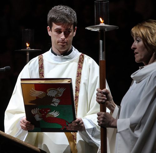 Thousands of Catholics gathered at the MTS Centre to take part in the Centennial Mass Sunday afternoon. A priest carries a holy book during the event. 150503 - Sunday, May 03, 2015 -  (MIKE DEAL / WINNIPEG FREE PRESS)