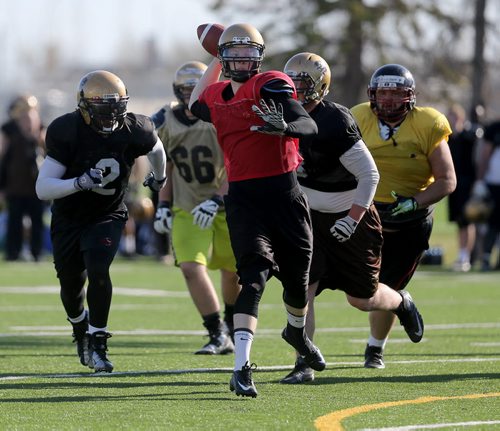 University of Manitoba Bisons Ashton Mackinnon throws a td pass on the run during spring camp, Sunday, May 3, 2015. (TREVOR HAGAN/WINNIPEG FREE PRESS)