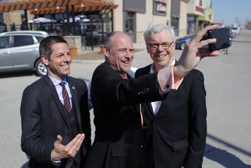 LOCAL - Mayor Brian Bowman, Drew Caldwell, Minister of Municipal Government, Premier Greg Selinger. Press conference at Boston Pizza parking lot, corner of Ness Avenue and St. James Street TOPIC: Province's annual funding to the City of Winnipeg to improve city streets and create jobs. BORIS MINKEVICH/WINNIPEG FREE PRESS May 4, 2015