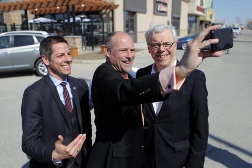 LOCAL - Mayor Brian Bowman, Drew Caldwell, Minister of Municipal Government, Premier Greg Selinger. Press conference at Boston Pizza parking lot, corner of Ness Avenue and St. James Street TOPIC: Province's annual funding to the City of Winnipeg to improve city streets and create jobs. BORIS MINKEVICH/WINNIPEG FREE PRESS May 4, 2015