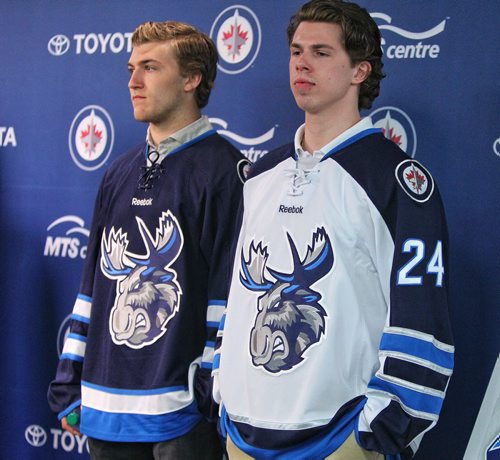 Manitoba Moose players Scott Kosmachuk (right) and JC Lipon (left) model the new jersey for the Winnipeg Jets affiliate AHL team which is moving back to Winnipeg next season.  150504 May 4, 2015 Mike Deal / Winnipeg Free Press