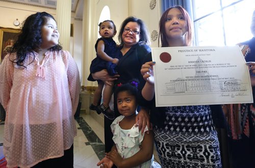 After her swearing in ceremony Monday in the Manitoba Legislative Building, in centre is new MLA for The Pas Amanda Lathlin holding her daughter Caitlin with her family from left Natanis, Nikkita and Elyse holding the certificate.  see release Wayne Glowacki / Winnipeg Free Press May 4 2015
