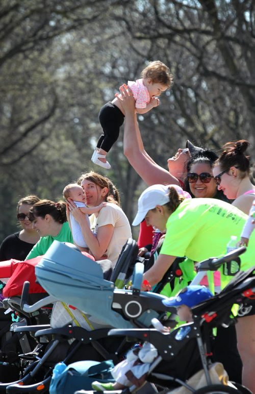 Danica Benson plays with 7-month-old Larkyn during a break in the stroller training workout at Assinibone Park. 


49.8 Certified post and pre natal trainer, Cindy Miller (front of crowd, red hair with pony tail) hosts workout sessions for new moms at Assiniboine park recently.  Classes last 45 - 50 minutes - moms walk vigorously for 5 minutes with their strollers, then pause to do lunges, step-ups, etc. for 5 minutes, then walk again, stop again until meeting back at the starting point, the pavilion, to do a cool down stretch.    See story Dave Sanderson's story. May 01, 2015 Ruth Bonneville / Winnipeg Free Press