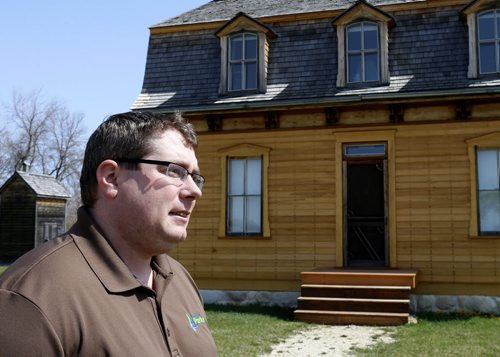 Sloan Cathcart, Head of Interpretation with the Manitoba Conservation and Water Stewardship at the St. Norbert Heritage Provincial Park. The house at right is the Bohémier House. Bill Redekop story Wayne Glowacki / Winnipeg Free Press May 5 2015