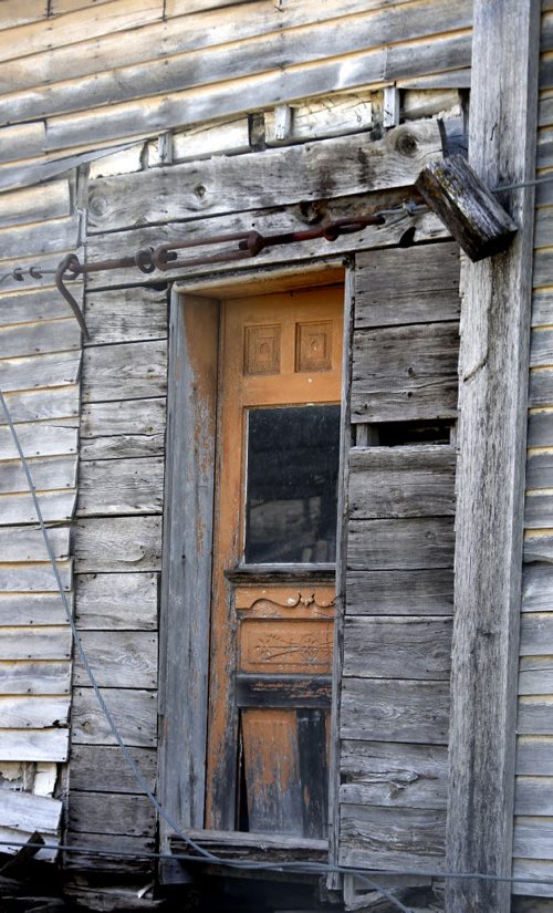The door on the historical Henderson House, the house is in a fenced off section at St. Norbert Heritage Provincial Park.  Henderson House, 7th oldest house in Manitoba, built in either 1854 or 1856 is being stored here behind a chain-link fence. Jim Smith, president of the North East Winnipeg Historical Society would like to see it restored and moved to Bunn's Creek Park in East Kildonan.   Bill Redekop story Wayne Glowacki / Winnipeg Free Press May 5 2015