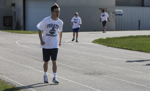Ben Gunnarsson, 21, who is in teacher Bobbi Milberg's special education physical education class was training on the field beside Grant Park Collegiate Tuesday morning. Some of the intellectually challenged students will be taking part in this years provincial track and field championships. 150505 - Tuesday, May 05, 2015 -  (MIKE DEAL / WINNIPEG FREE PRESS)