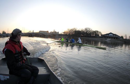 49.8 BORDERS - Head coach for The Winnipeg Rowing Club Steven Taylor, left, carefully watches a crew on the cold Red River. BORIS MINKEVICH/WINNIPEG FREE PRESS May 5, 2015