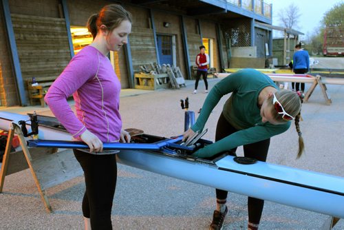 49.8 BORDERS - The Winnipeg Rowing Club. (L-R) Drew Wiebe gets some help from Amy Kroeker setting her boat up just before they hit the water. BORIS MINKEVICH/WINNIPEG FREE PRESS May 5, 2015