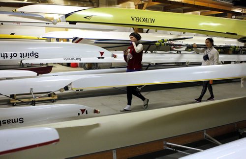 49.8 BORDERS - The Winnipeg Rowing Club.(L-R) Emily Lennox and Hanika Nakagawa helps get the oars out. BORIS MINKEVICH/WINNIPEG FREE PRESS May 5, 2015