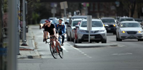 City cyclists make full use of the protected and dedicated bike lane along Sherbrook Street Tuesday afternoon. See story. May 5, 2015 - (Phil Hossack / Winnipeg Free Press)