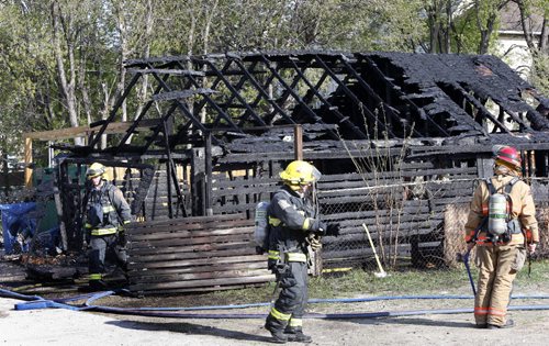 Winnipeg Fire Fighters at the scene of a garage fire behind a house in the 500 block of Mountain Ave. Wednesday morning. Wayne Glowacki / Winnipeg Free Press May 6 2015