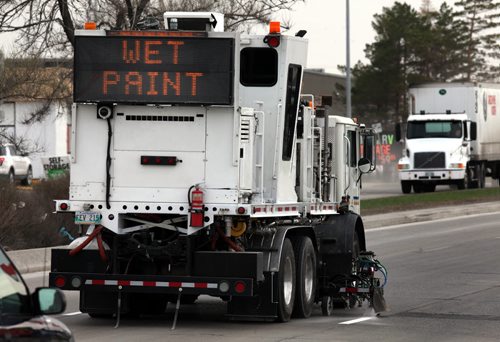 A truck speeds down Regent Ave Wednesday morning painting lane markers en-route.  See story. May 6, 2015 - (Phil Hossack / Winnipeg Free Press)