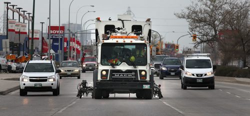 A truck speeds down Regent Ave Wednesday morning painting lane markers en-route.  See story. May 6, 2015 - (Phil Hossack / Winnipeg Free Press)