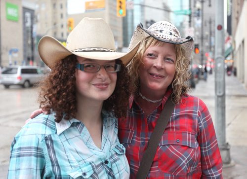 Samantha Mozdzen (left) and her mom Marnie are all smiles as they make their way into the MTS Centre to see one of Marnie's favourite bands, Luke Bryan Wednesday night.   Wednesday, May 06/15 Ruth Bonneville  / Winnipeg Free Press