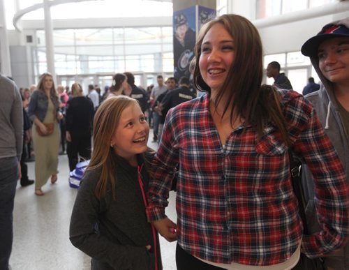 Eight-year-old Jersi Godfrey (left),  her cousins Carrie Godfrey and Troy Godfrey are all smiles as they make their way into the MTS Centre to see Luke Bryan Wednesday night.   Wednesday, May 06/15 Ruth Bonneville  / Winnipeg Free Press
