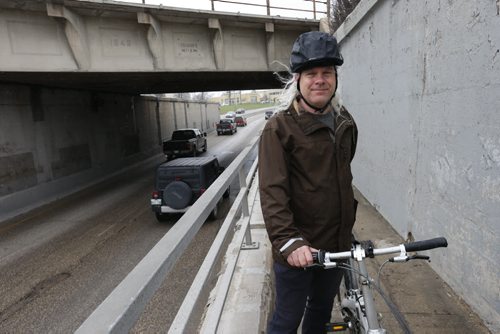 Mark Cohoe, executive director of Bike Winnipeg poses with his bike on  the sidewalk of the Pembina Highway Underpass.  Cycling along with the traffic at left  is a concern for cyclists.  This is part of the launch of readers submitting cycling trouble spots. Kristin Annable  story.  Wayne Glowacki / Winnipeg Free Press May 7 2015
