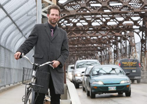 Anders Swanson, coordinator Winnipeg Trails Association poses with his bike on the sidewalk of the Arlington Bridge. He says the bridge is dangerous for cyclists . This is part of the launch for readers to submit cycling trouble spots.Kristin Annable  story.  Wayne Glowacki / Winnipeg Free Press May 7 2015
