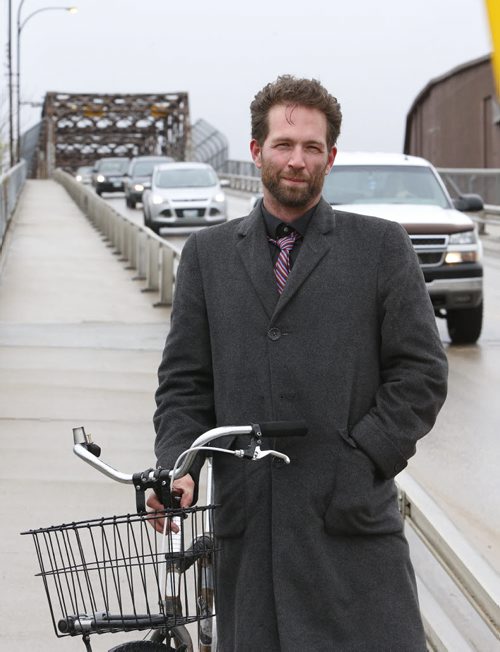 Anders Swanson, coordinator Winnipeg Trails Association poses with his bike on the sidewalk of the Arlington Bridge. He says the bridge is dangerous for cyclists . This is part of the launch for readers to submit cycling trouble spots.Kristin Annable  story.  Wayne Glowacki / Winnipeg Free Press May 7 2015