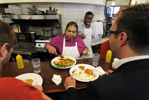 Famena's Famous Roti - 295 Garry Street. Sanderson story. (L-R back) Famena and Mohammed Ally run the restaurant.  Here they show off some of their good food. BORIS MINKEVICH/WINNIPEG FREE PRESS May 7, 2015