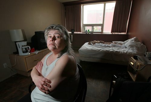 Debbie Teachy poses in her temporary quarters at the Quest Inn. She's one of several Manitoba Housing residents who are upset that they are still out of their homes over 2 weeks after the flood at 185 Smith St. They are speaking out about the challenges and difficulties as a result of living in a hotel and not knowing whats happening. See Kathleen Saylors story. May 8, 2015 - (Phil Hossack / Winnipeg Free Press)