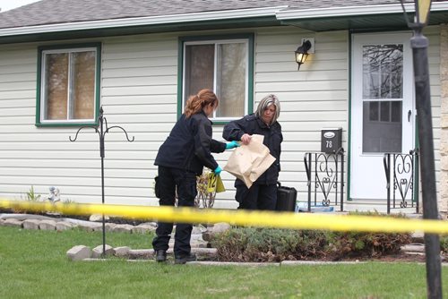 Police investigators collect evidence from the scene of a stabbing that took place just before 5am Saturday morning in a quiet neighbourhood of Transcona at 78 Perry Bay.  May 09, 2015 Ruth Bonneville / Winnipeg Free Press