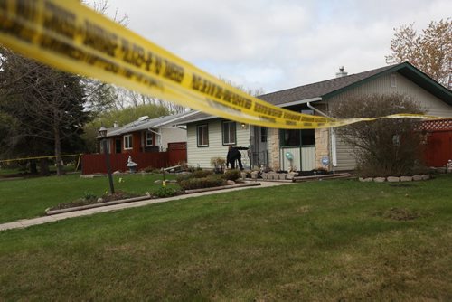 A police investigator leaves the scene of a stabbing that took place just before 5am Saturday morning in a quiet neighbourhood of Transcona at 78 Perry Bay.  May 09, 2015 Ruth Bonneville / Winnipeg Free Press