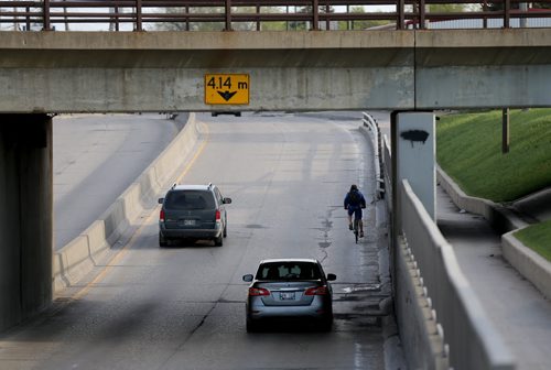 A cyclist near the underpass on Archibald, Saturday, May 9, 2015. (TREVOR HAGAN/WINNIPEG FREE PRESS)