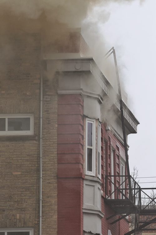 Thick black smoke pours out of a four-storey building, which is empty and undergoing renovations, at 543 Bannatyne Ave. Police have closed off streets for blocks around the fire.  150510 May 10, 2015 Mike Deal / Winnipeg Free Press
