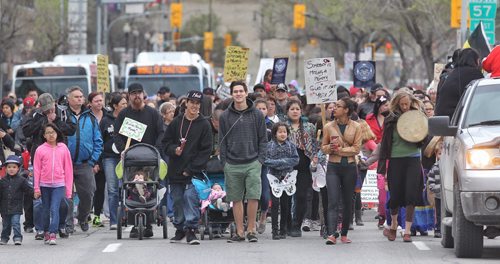 Crossing Main Street at York Avenue the Sisters in Spirit annual Mothers Day Walk honouring missing and murdered Aboriginal women started at the St-Regis Hotel (285 Smith) and ended at the Oodena Circle at The Forks. 150510 May 10, 2015 Mike Deal / Winnipeg Free Press