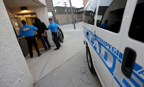 Police Cadet Adam Krasnesky and Cadet Josh Mrochuk transferring an IPDA to 75 Martha Street, for Katie May story, Friday, May 8, 2015. (TREVOR HAGAN/WINNIPEG FREE PRESS)