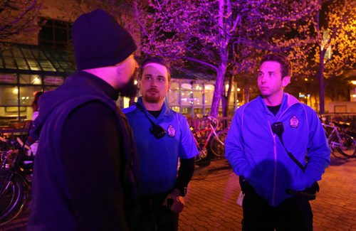 Police Cadet Adam Krasnesky and Cadet Josh Mrochuk, speaking with an event organizer at The Forks, for Katie May story, Friday, May 8, 2015. (TREVOR HAGAN/WINNIPEG FREE PRESS)