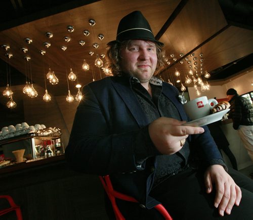 Maxim Berent owner of BerMax Caffe  poses with a capuccino and pastry. See Marion Warhaft's story. May 11, 2015 - (Phil Hossack / Winnipeg Free Press)