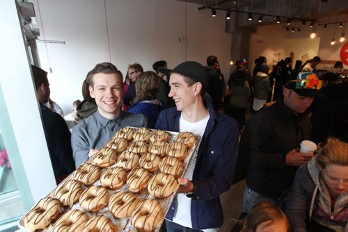 Intersection piece on Bronuts - Winnipeg's first, dedicated gourmet doughnut shop owned by Brett (left) and Dylan Zahari - brothers who put the Bro in Bronuts.  Brothers hold tray of peanut butter, chocolate Bronuts inside their cafe on a busy Saturday morning.   May 09, 2015 Ruth Bonneville / Winnipeg Free Press
