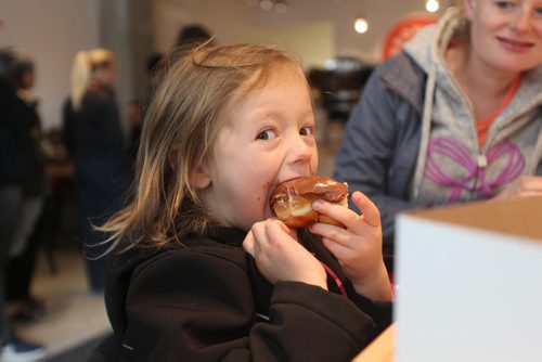Intersection piece on Bronuts - Winnipeg's first, dedicated gourmet doughnut shop owned by Brett and Dylan - brothers who put the Bro in Bronuts.  Four-year-old Myah Graham chomps into a Nutella Chocolate Donut on a recent Saturday morning visit with family.   May 09, 2015 Ruth Bonneville / Winnipeg Free Press