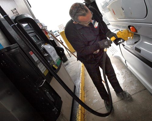 Andre LaPalme tops up the saddle tanks on his rig in Winnipeg Tuesday. He's headed to the mid west USA from Montreal. See story re: fuel prices. May 12, 2015 - (Phil Hossack / Winnipeg Free Press)