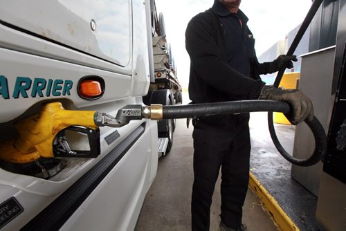 Andre LaPalme tops up the saddle tanks on his rig in Winnipeg Tuesday. He's headed to the mid west USA from Montreal. See story re: fuel prices. May 12, 2015 - (Phil Hossack / Winnipeg Free Press)