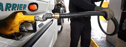 Andre LaPalme tops up the saddle tanks on his rig in Winnipeg Tuesday. He's headed to the mid west USA from Montreal. See story re: fuel prices. May 12, 2015 - (Phil Hossack / Winnipeg Free Press)