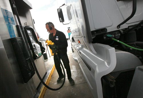 Andre LaPalme tops up the saddle tanks on his rig in Winnipeg Tuesday. He's headed to the mid west USA from Montreal. See story re: fuel prices. May 12, 2015 - (Phil Hossack / Winnipeg Free Press)