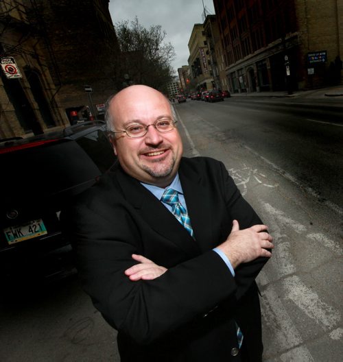 A grinning Russ Wyatt poses on a Princess st. bike lane Wednesday afternoon. See Bart Kives story re; Whyatt's opposition to such lanes..... May 13, 2015 - (Phil Hossack / Winnipeg Free Press)